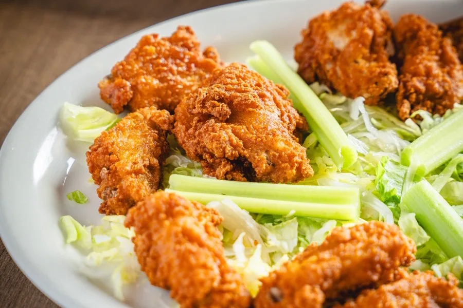 Crispy chicken wings served with celery