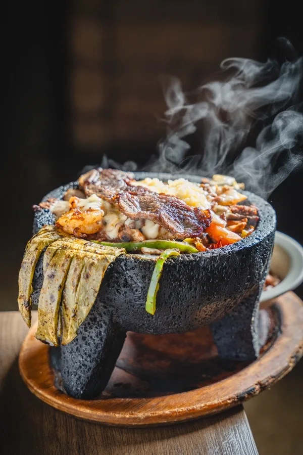 Molcajete: grilled meats sizzling in a stone bowl